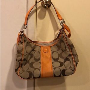 Orange and tan gently used medium sized coach bag